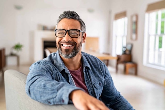 Mature ethnic man wearing eyeglasses at home